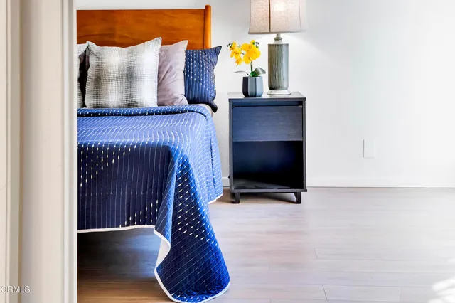 a view of staircase with wooden floor and a potted plant