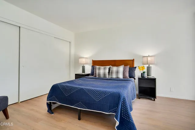 a bedroom with a bed and lamp