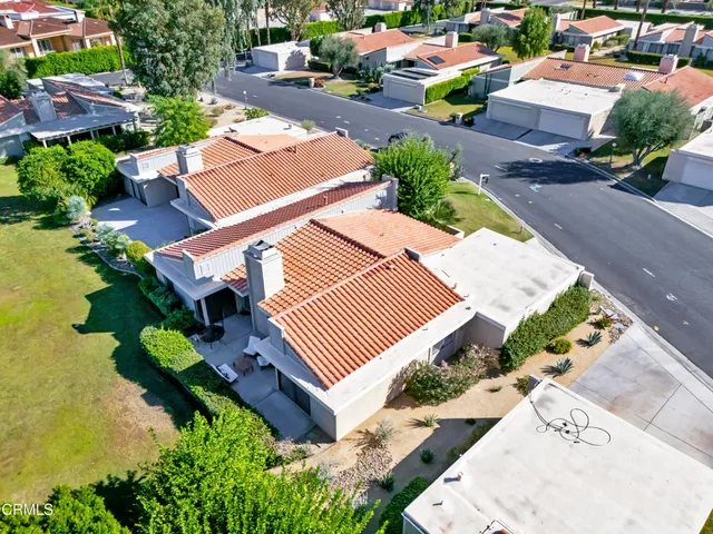 an aerial view of a house with swimming pool and outdoor space