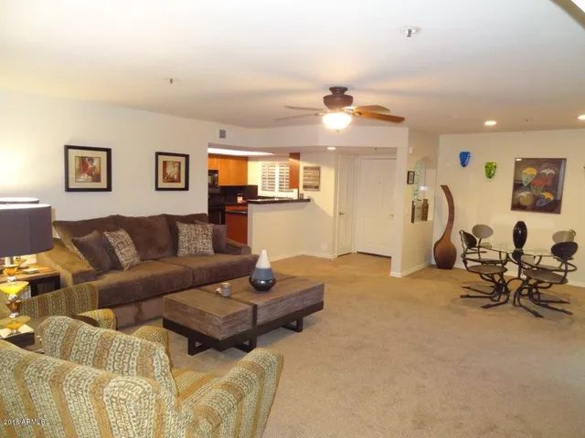 a living room with furniture a window and gym equipment