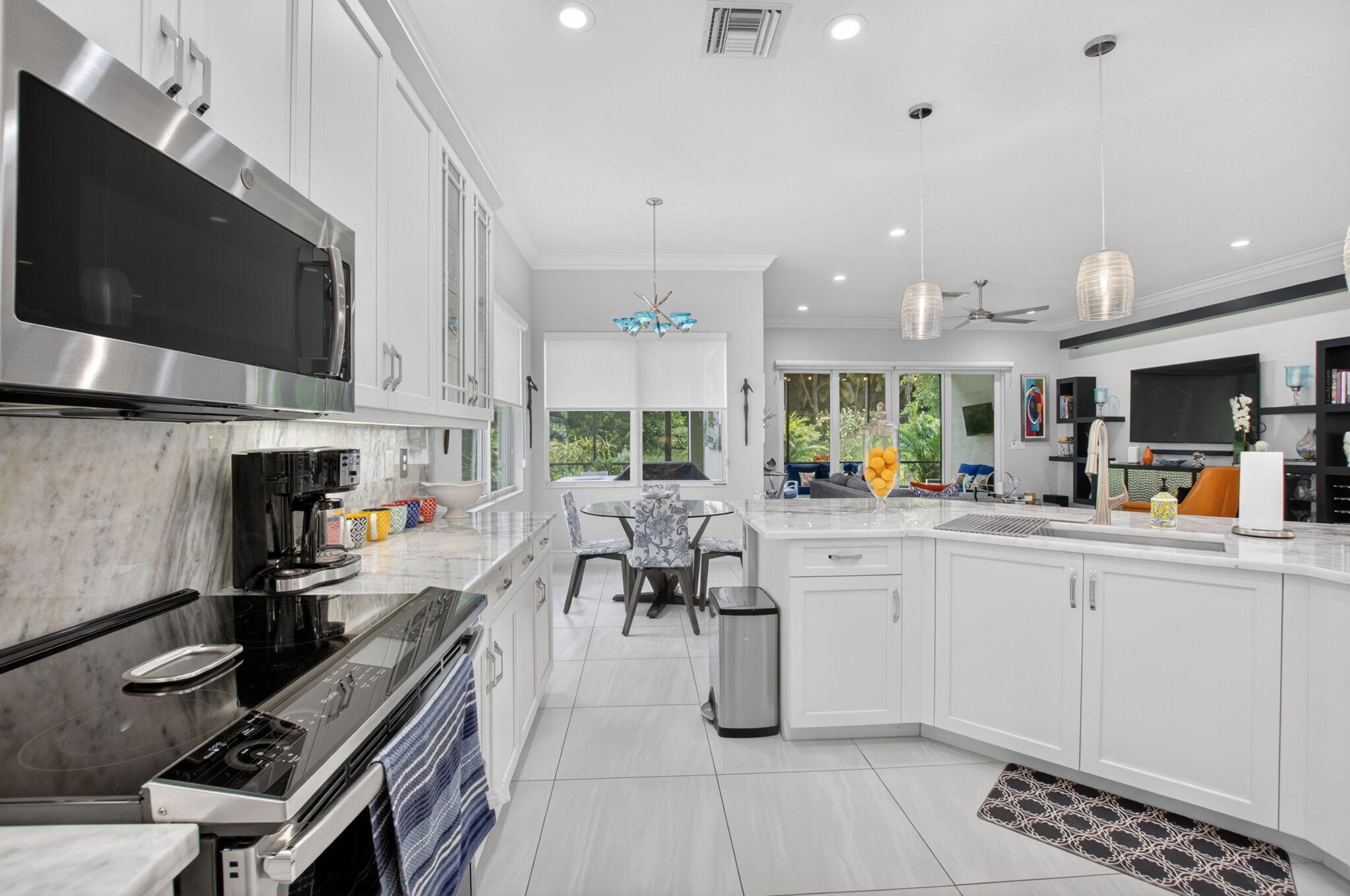 8263 Arabian Range Road Boynton Beach, FL 33473 - Photo 28 of 52 a kitchen with stainless steel appliances kitchen island granite countertop a stove and a sink