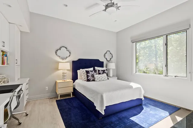 a bedroom with two beds and a large window