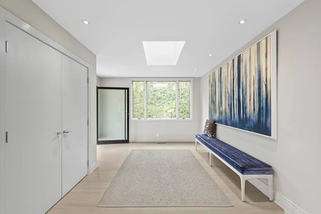 a living room with furniture a fireplace and a chandelier