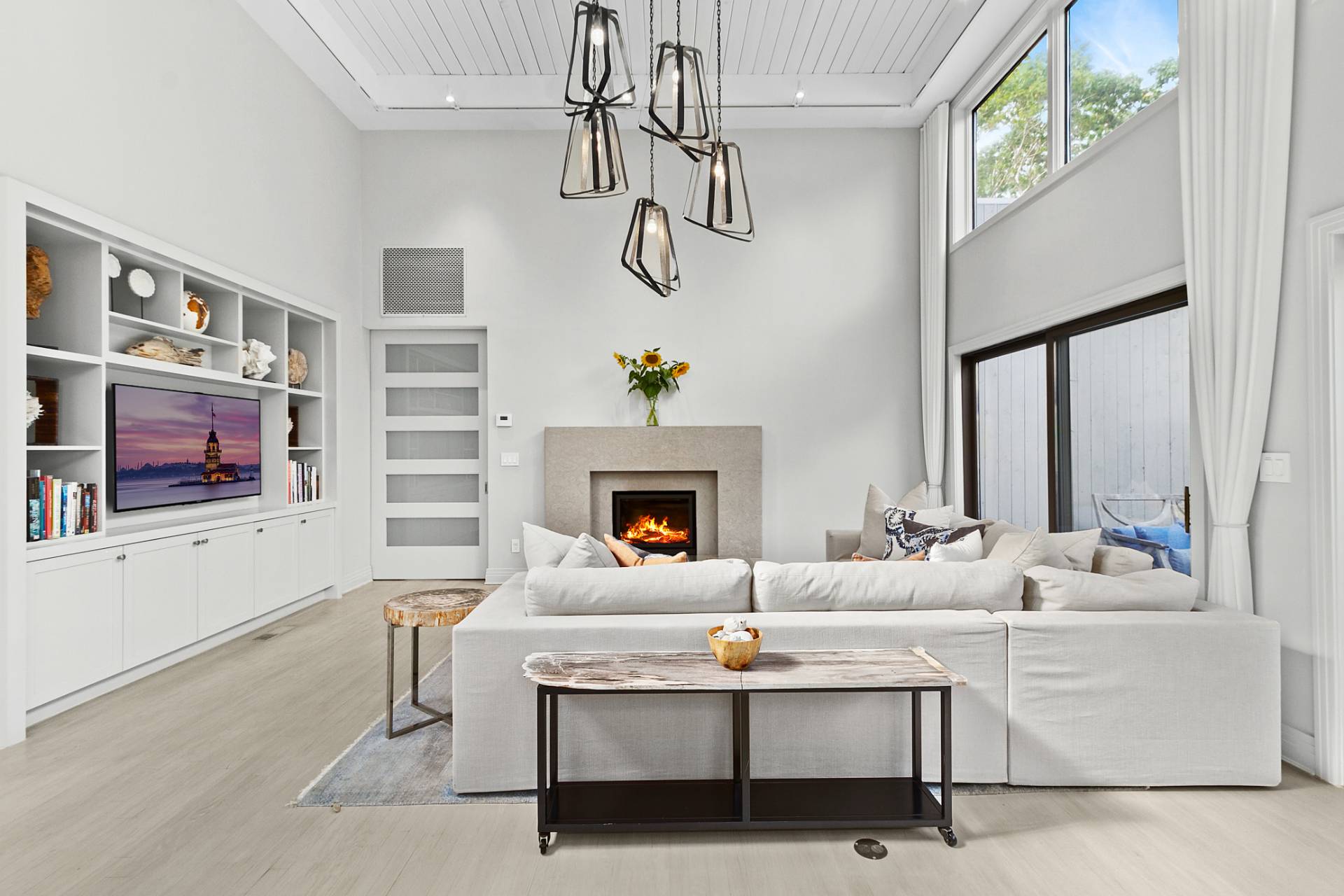 1705 Noyack Road Southampton, NY 11968 - Photo 6 of 16 a living room with furniture a fireplace and a chandelier