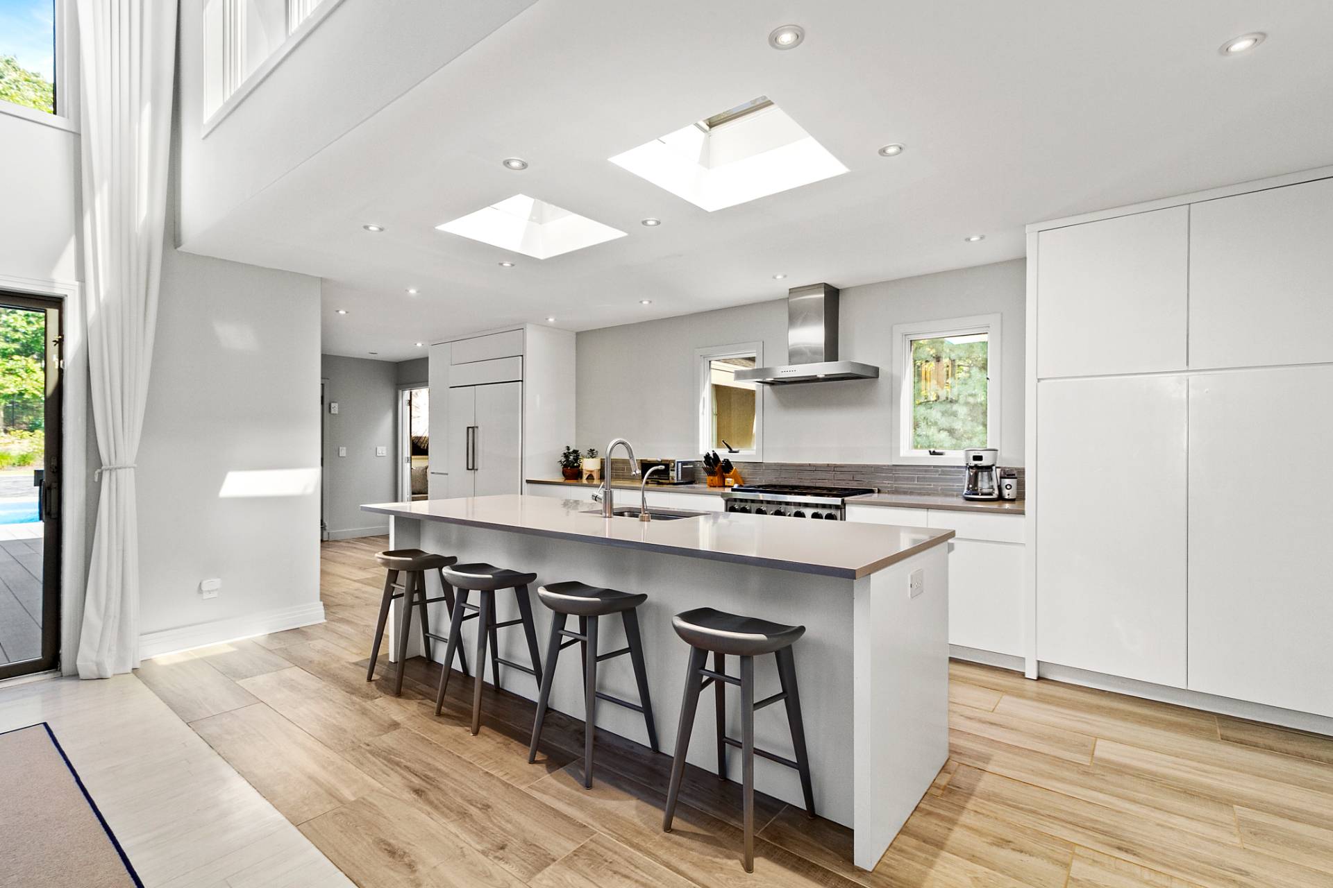 1705 Noyack Road Southampton, NY 11968 - Photo 8 of 16 a kitchen with stainless steel appliances granite countertop a sink stove and refrigerator