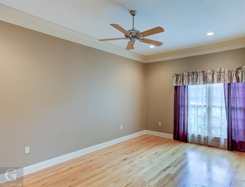1212 WPA Road Homer, LA 71040 - Photo 16 of 35 Spare room featuring ornamental molding, baseboards, hardwood / wood-style flooring, a ceiling fan, and recessed lighting