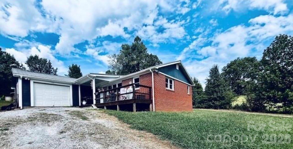 a view of a house with a backyard
