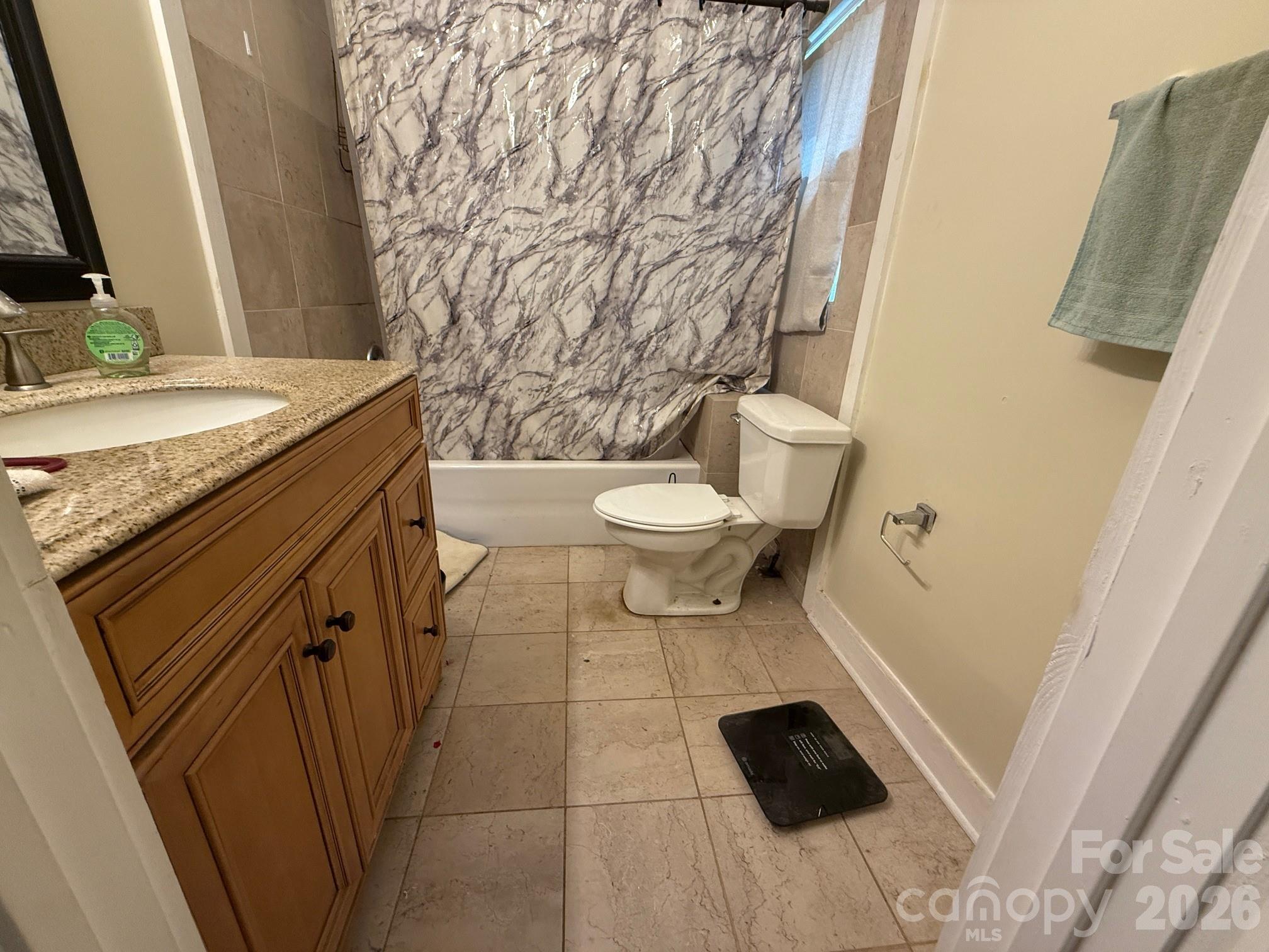 54 Dee Cable Drive Marion, NC 28752 - Photo 11 of 16 a bathroom with a granite countertop toilet sink and mirror