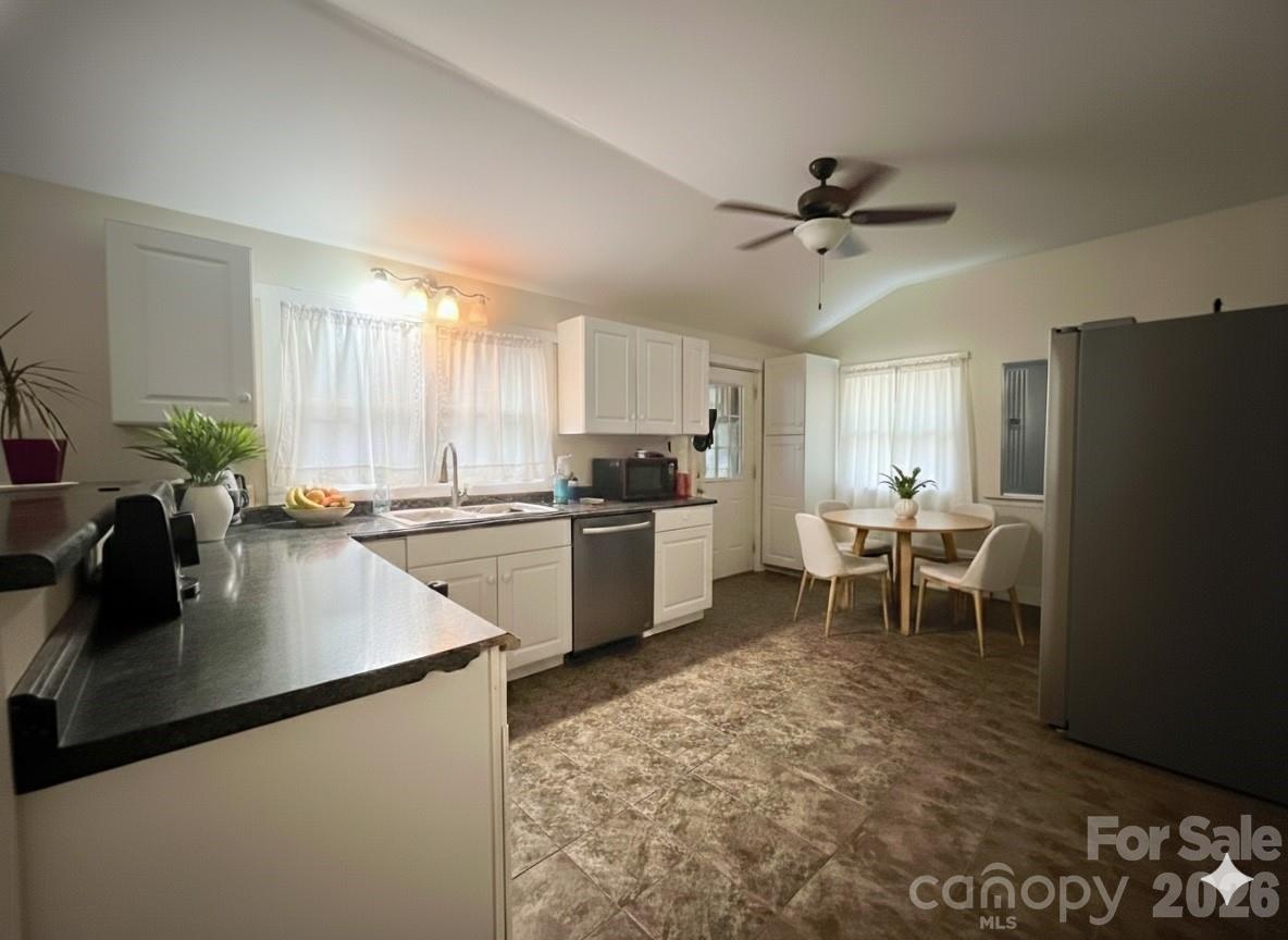 54 Dee Cable Drive Marion, NC 28752 - Photo 5 of 16 a kitchen with granite countertop a refrigerator a sink a stove and cabinets