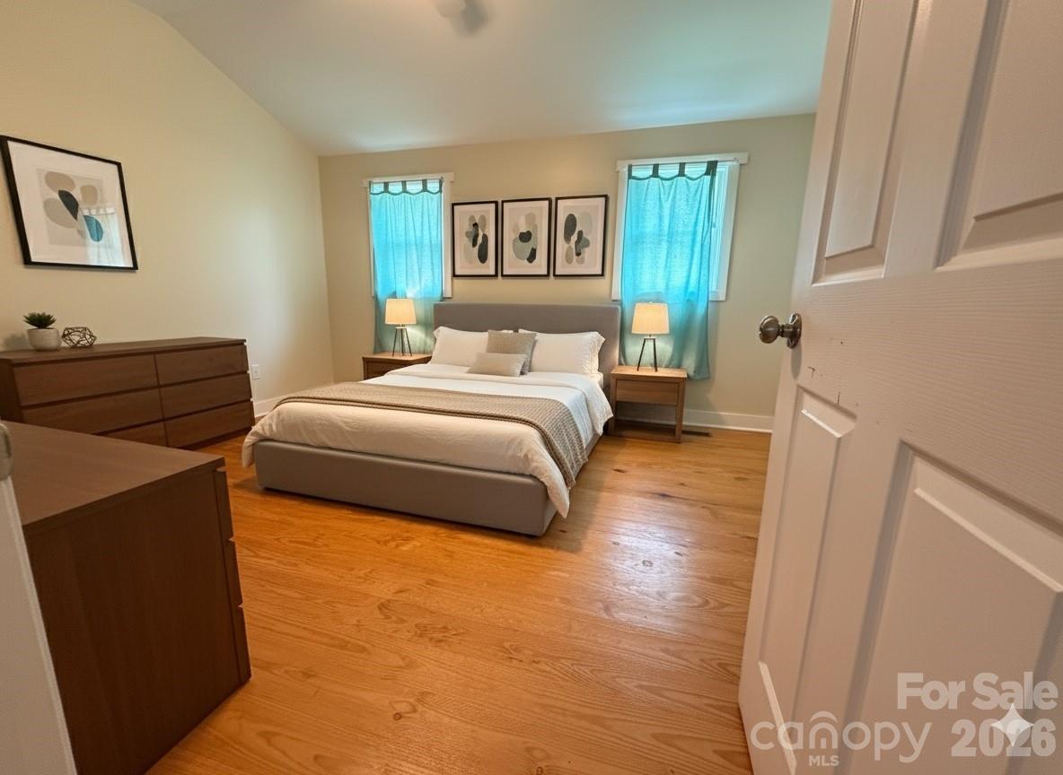 54 Dee Cable Drive Marion, NC 28752 - Photo 9 of 16 a bedroom with a bed and a painting on the wall