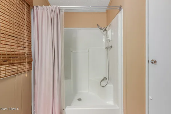 a bathroom with a glass shower door
