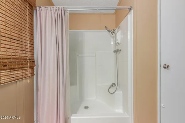 a bathroom with a glass shower door