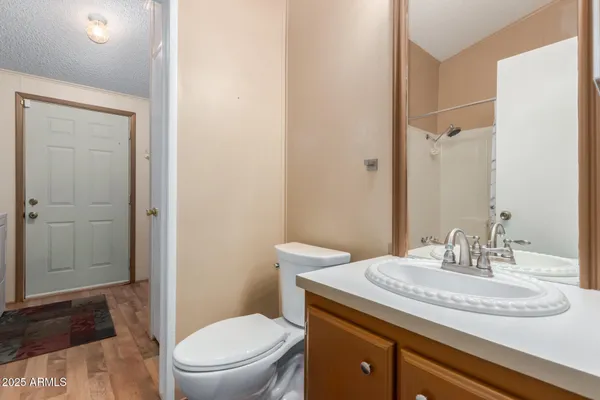 a bathroom with a granite countertop sink toilet and shower