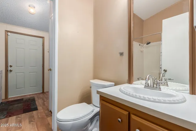 a bathroom with a granite countertop sink toilet and shower