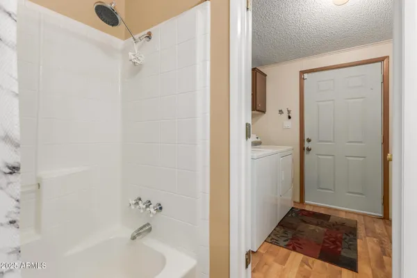 a bathroom with a tub shower and sink