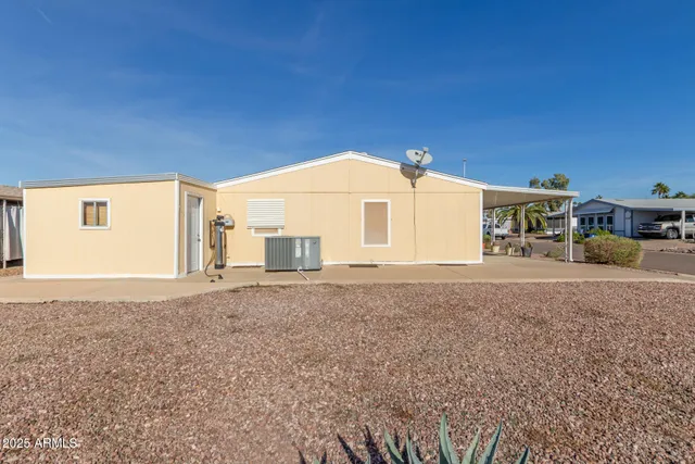 a view of a house with backyard and a tree
