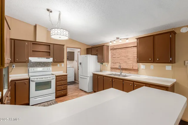 a kitchen with stainless steel appliances a stove cabinets and wooden floor