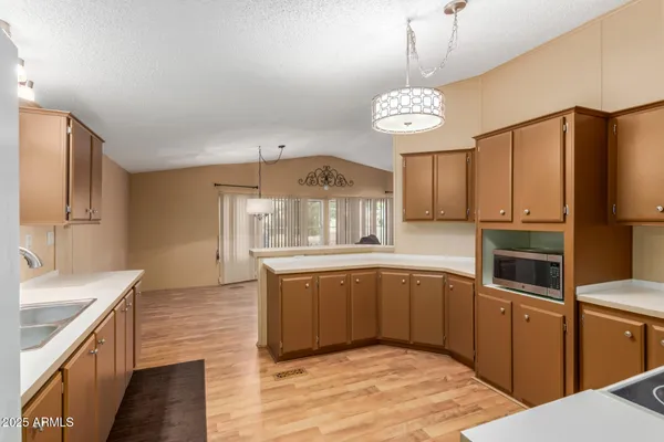 a kitchen with stainless steel appliances granite countertop a sink dishwasher stove and refrigerator