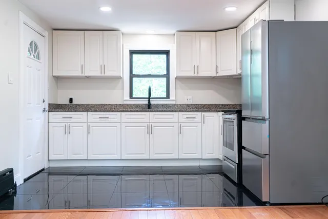 a kitchen with white cabinets