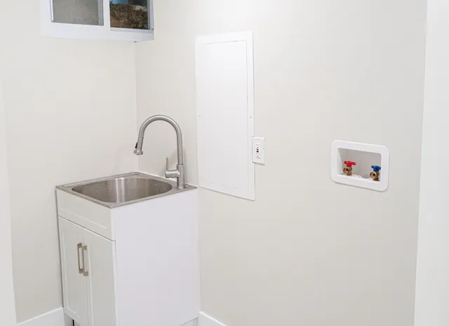 a close view of a sink a faucet and cabinets