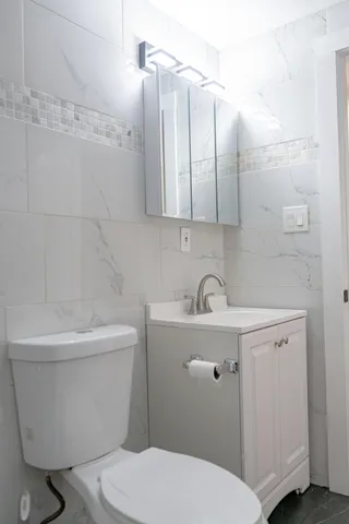 a bathroom with a sink a toilet and bathtub