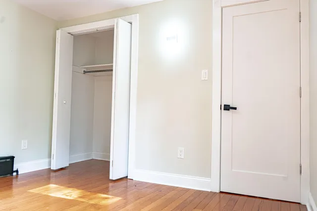 a view of a room with wooden floor