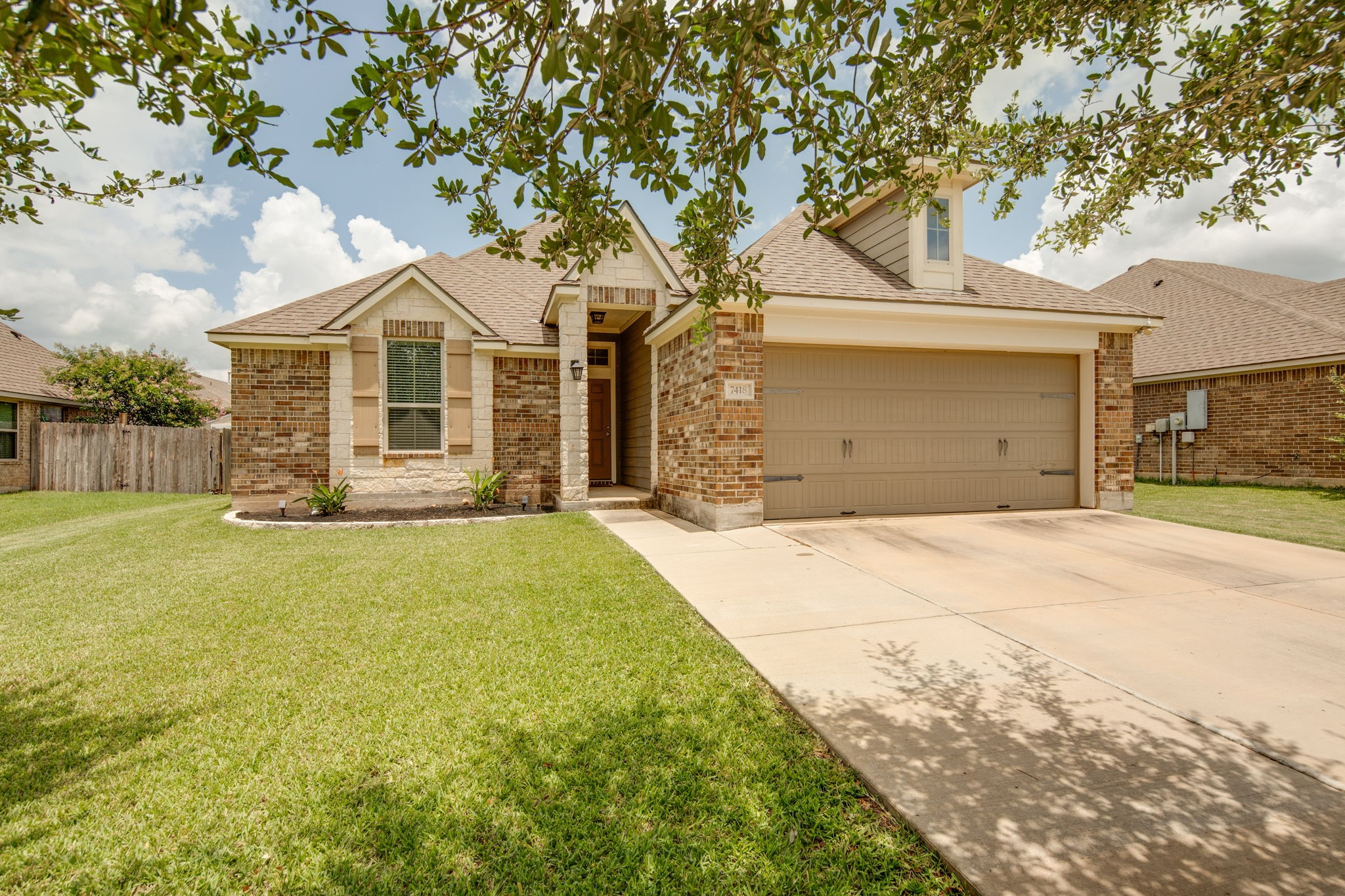 a front view of a house with a yard and garage