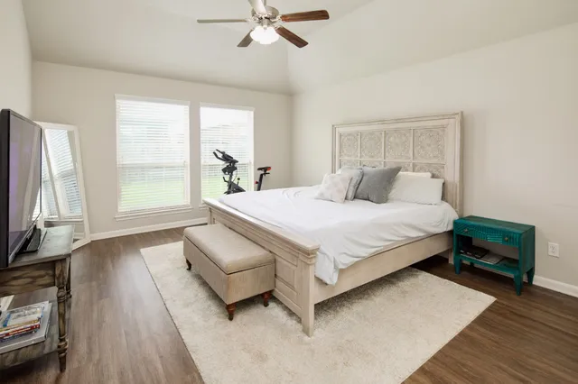 a bedroom with a bed and a flat screen tv