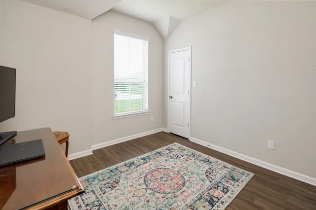 an empty room with wooden floor