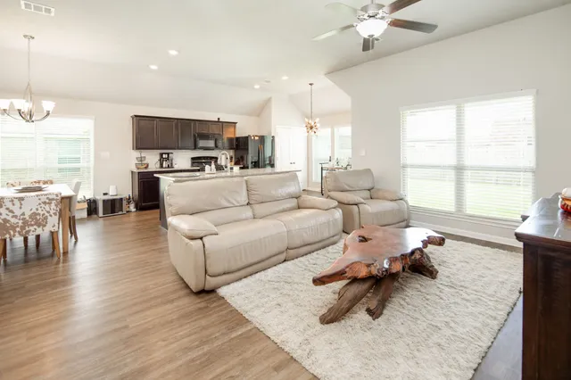 a living room with furniture and a large window