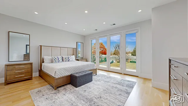 a bedroom with a large bed and a window