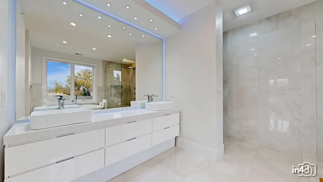 a bathroom with a double vanity sink and a mirror