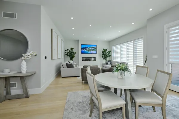 a living room with furniture a flat screen tv and kitchen view