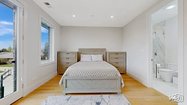 a bedroom with a bed and bathroom