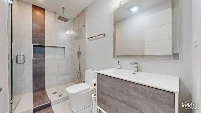 a bathroom with a sink toilet and shower