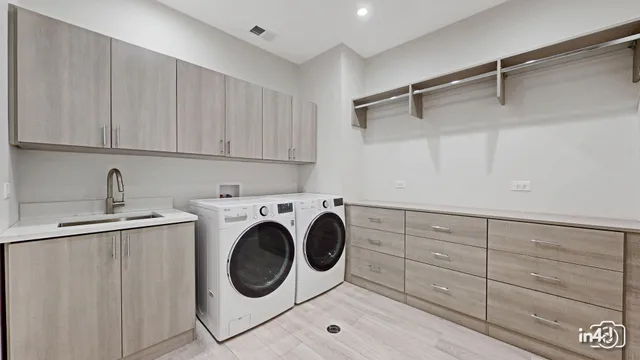 a utility room with sink dryer and washer
