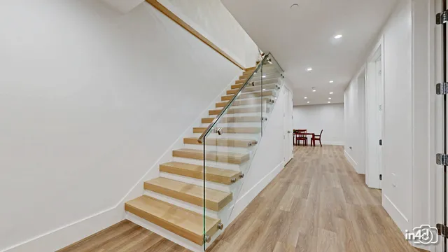 a view of entryway and hall with wooden floor