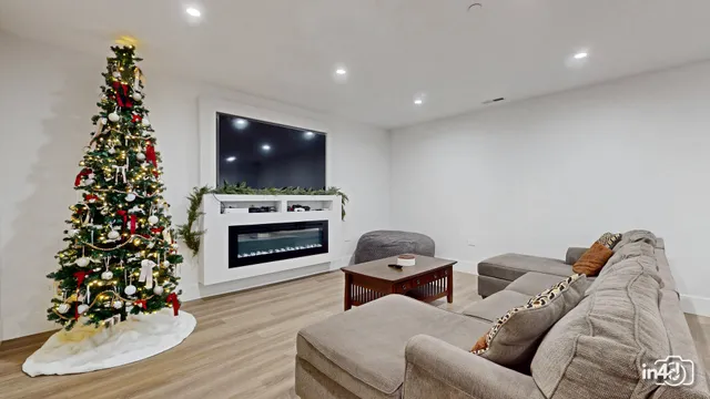 a living room with furniture a flat screen tv and a fireplace