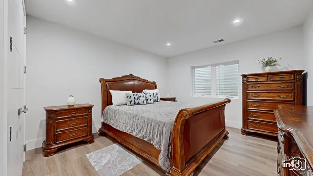 a bedroom with a bed and a dresser