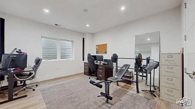 a view of a workspace with furniture and a window