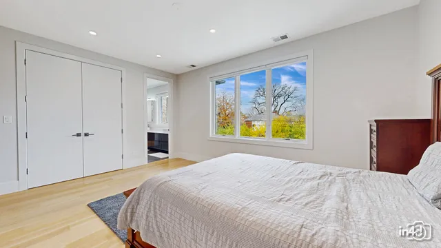 a bedroom with a bed and painting on the wall