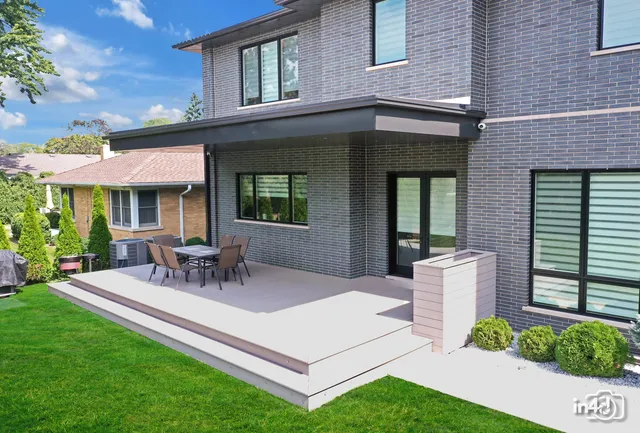 a view of a house with a yard and sitting area