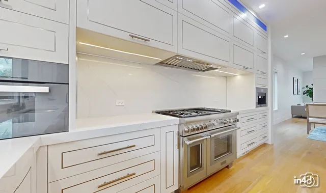a kitchen with stainless steel appliances white cabinets and a stove