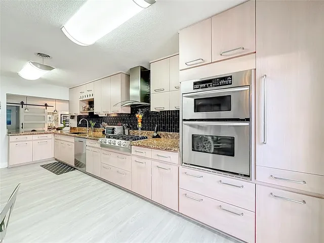 a spacious bathroom with a double vanity sink toilet mirror and shower