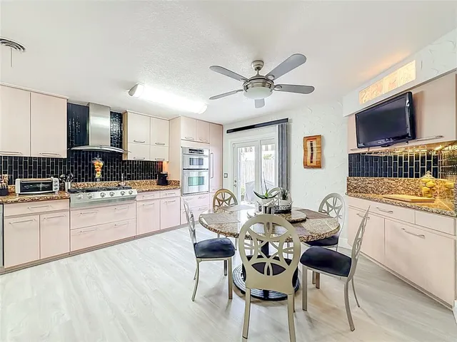 a bedroom with bed tv and a chandelier