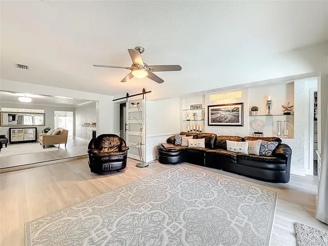 a view of a house with backyard porch and furniture