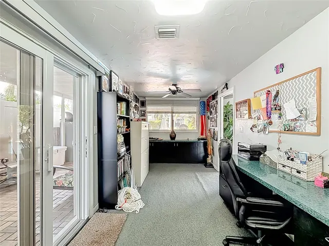 a view of a patio with table and chairs potted plants and palm tree