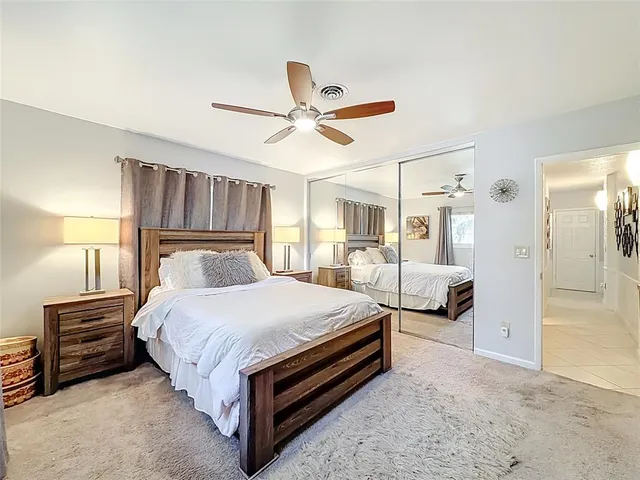 a view of a lake with boats and palm trees