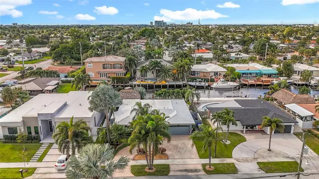 a kitchen with a dining table chairs and white cabinets