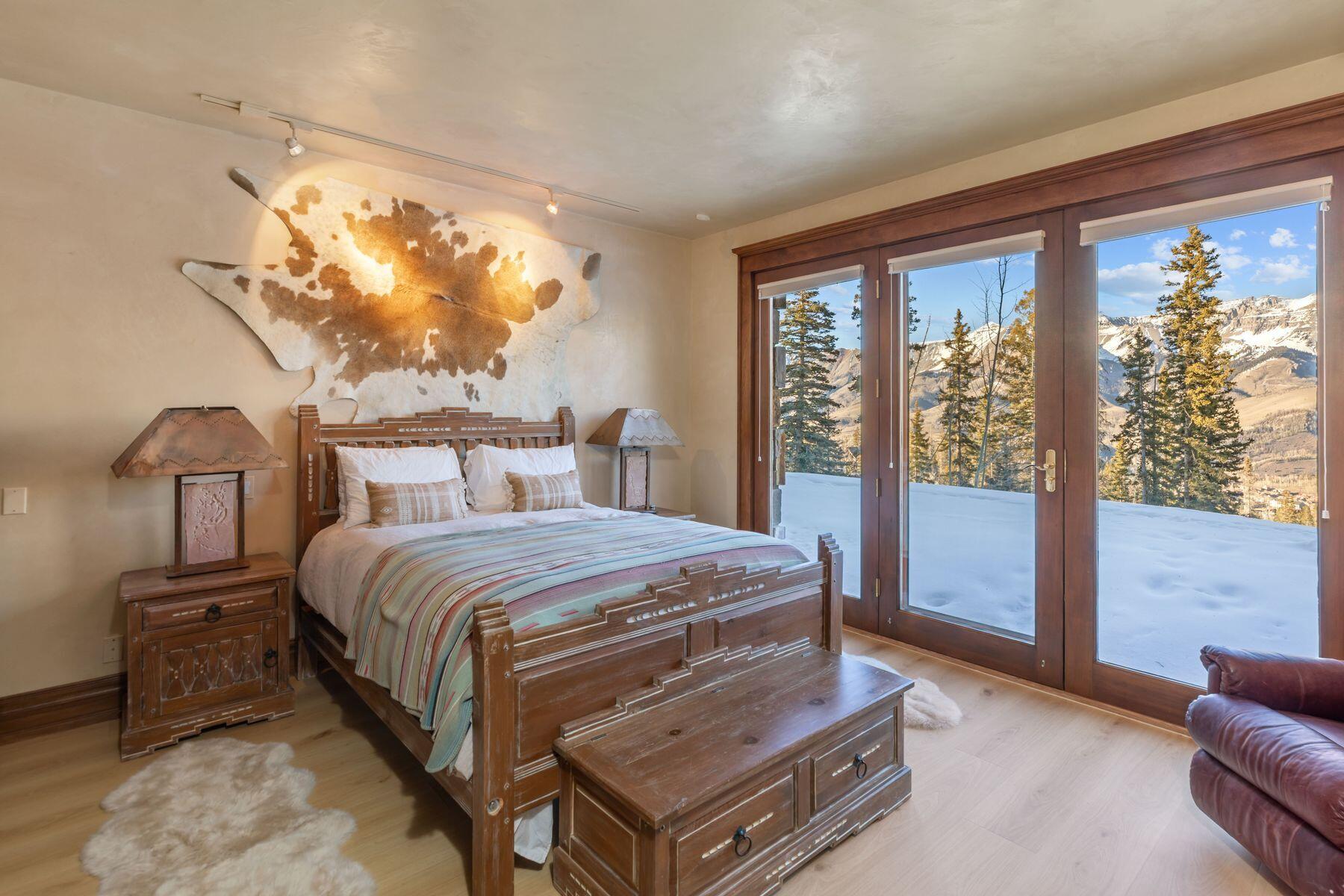 222 High Country Road Mountain Village, CO 81435 - Photo 17 of 37 a bedroom with a bed and a large window